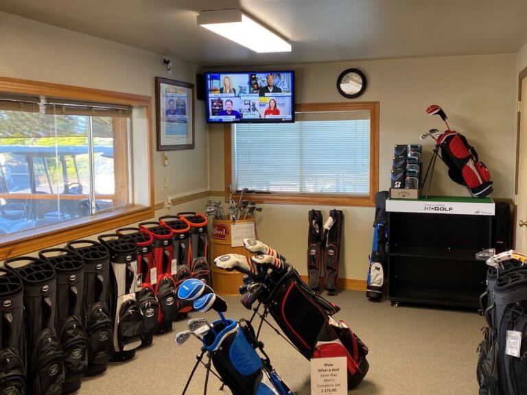 Golf bags and club sets displayed in pro shop corner