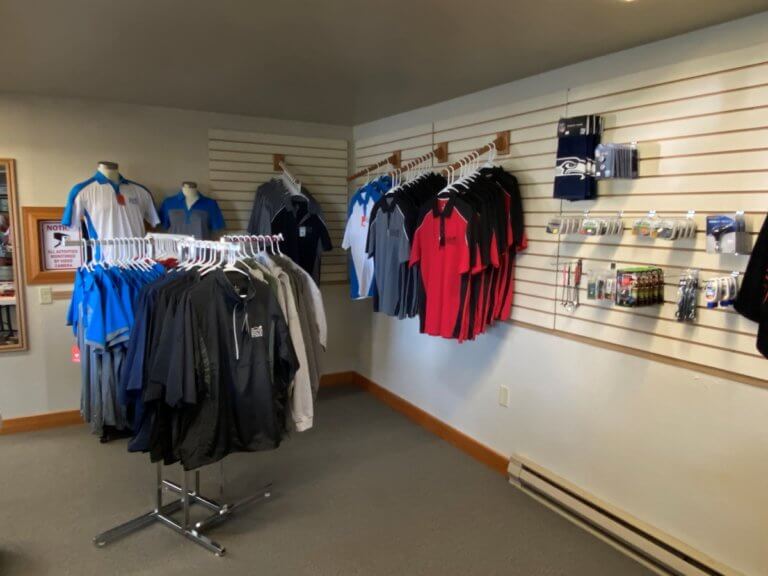 Shirts, jackets, and golf accessories on display