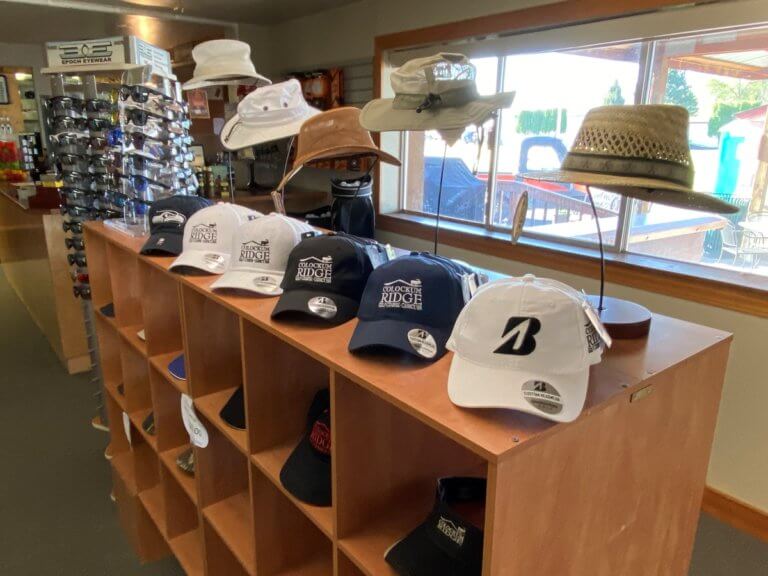 Golf hats and sunglasses on display in pro shop