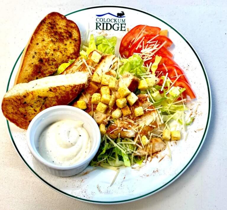 Chicken salad with croutons, tomato, and garlic bread