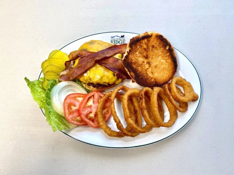 Bacon cheeseburger with onion rings and toppings
