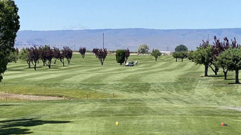 Scenic view down a lush fairway at Colockum Ridge Golf Course in Quincy, Washington.