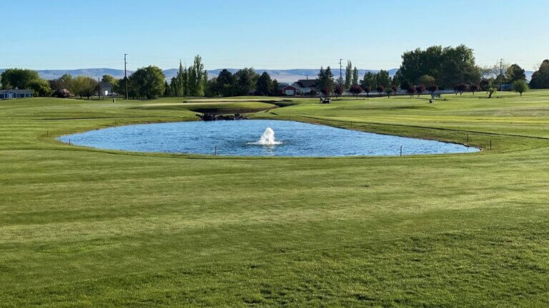 Pond with central fountain on the green at Colockum Ridge Golf Course
